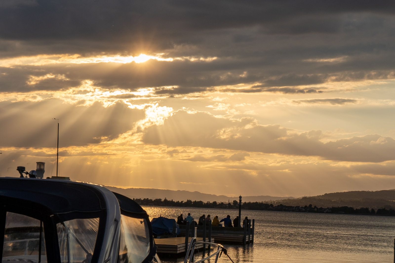 Second Deck Lake Cruises. Sunset rays over the water.