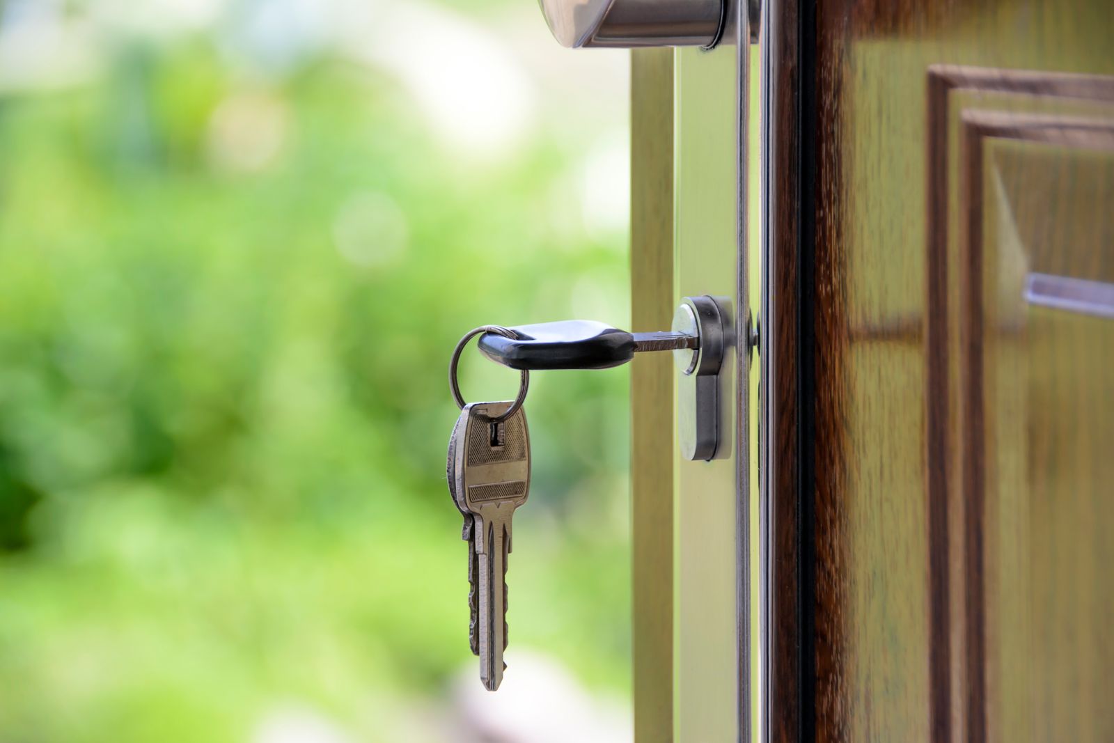 A key in a lock on a wooden door. Iron Latch.