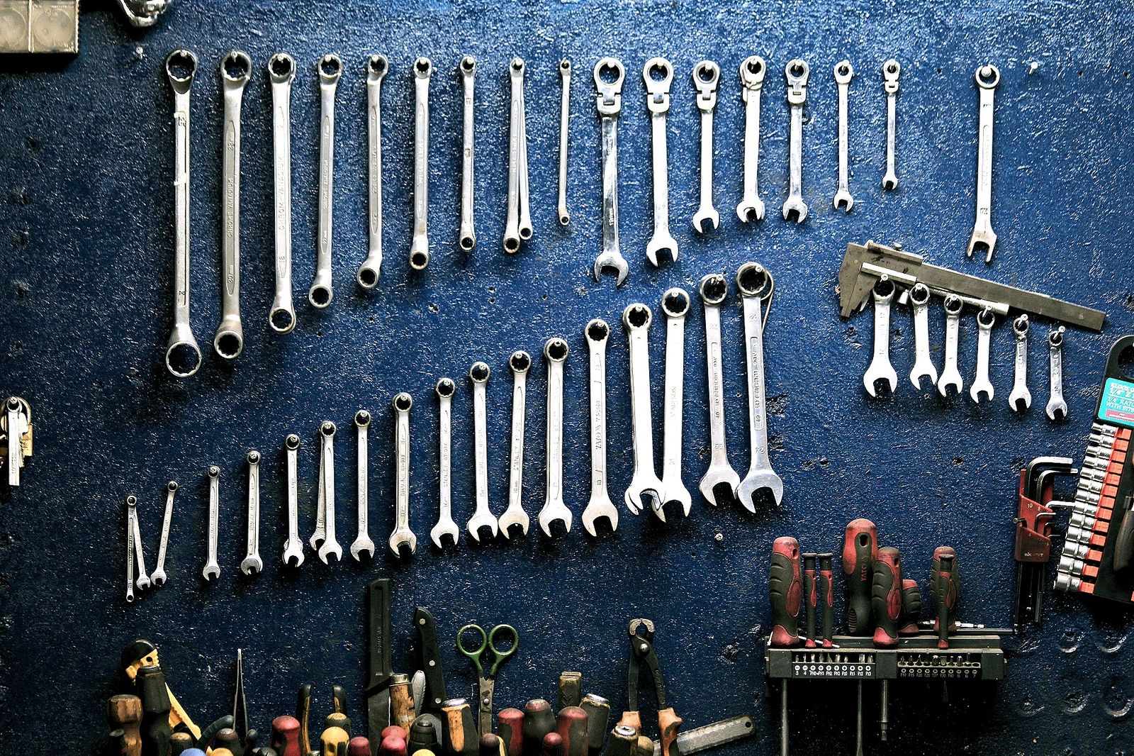 Iron Latch. Wrenches on a shop wall.