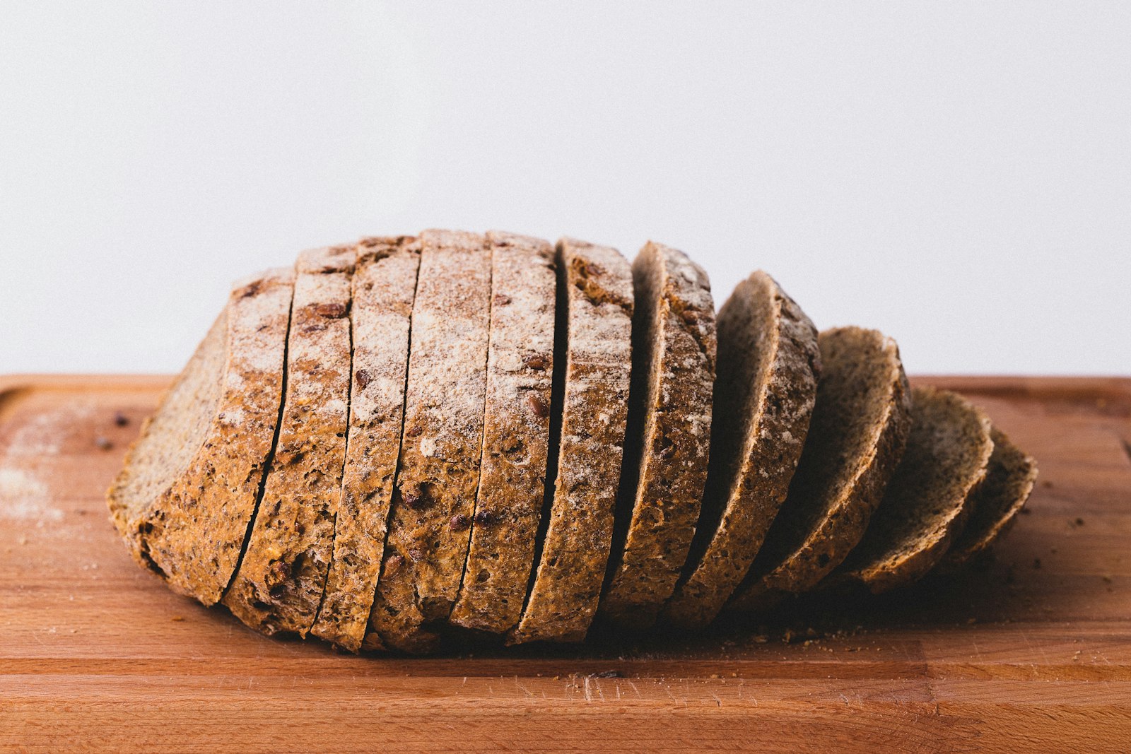 A sliced seeded loaf on a board. Late Light Bakery.