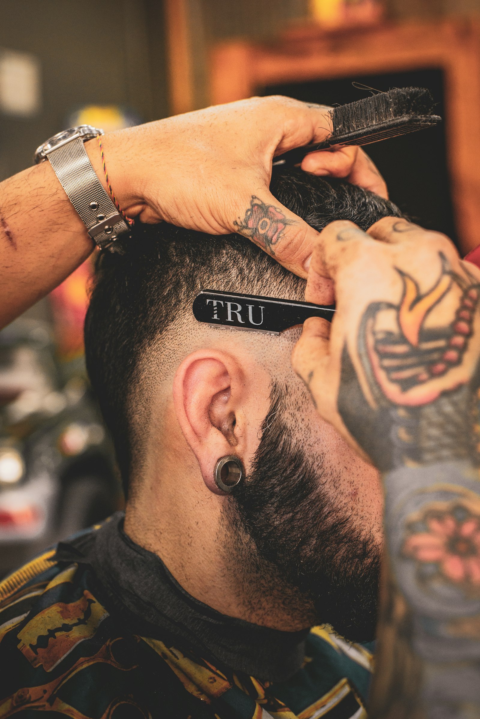 A barber cutting a fade. Open Chair.