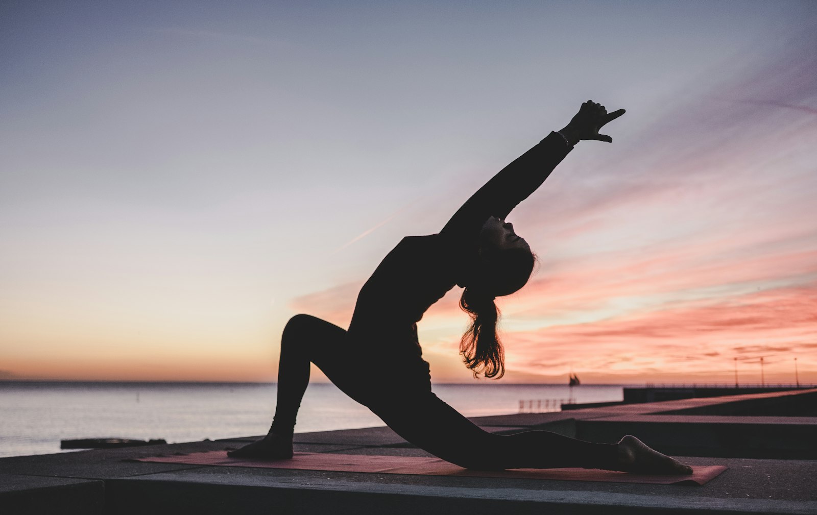 A person in a yoga pose. Quiet Mat.