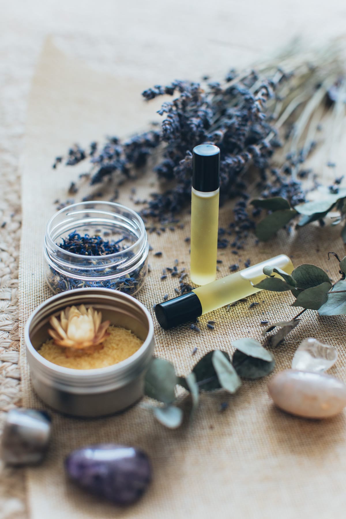 Essential oils and botanicals on warm wood.